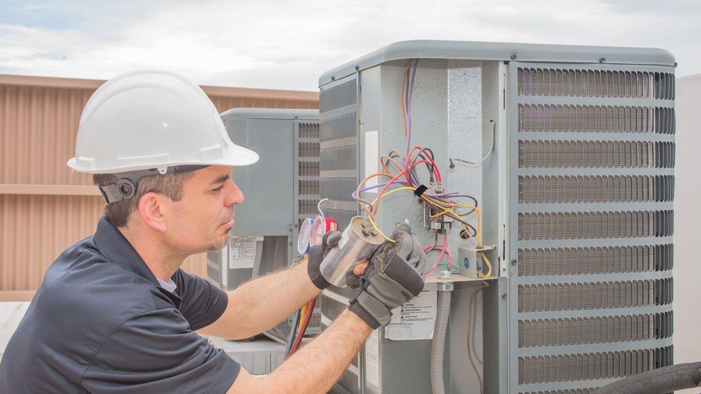 Technicians completing a residential central air conditioning installation