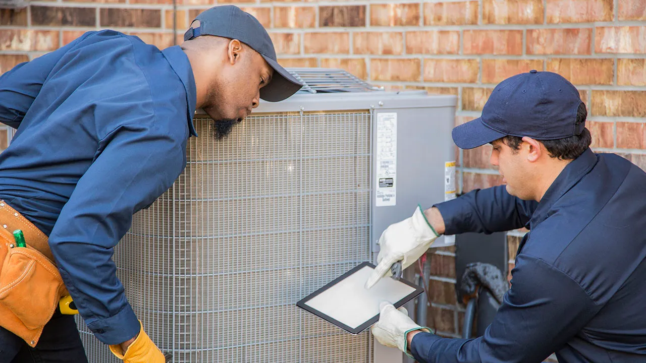 Technician performing a maintenance check on an air conditioning system